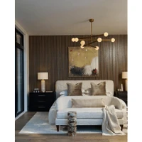 Modern Beaubien Chandelier with eight white globe bulbs and brass arms over a bed.
