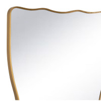 Piero Metal Mirror with a natural brass, ribbon-shaped frame and wavy top edge.