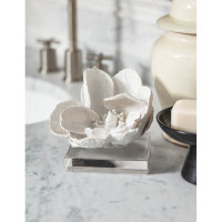 White magnolia bloom objet on a clear crystal base, 5" tall, on a marble counter.