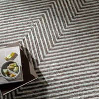 Charcoal grey and light grey striped viscose rug with a modern zigzag pattern.