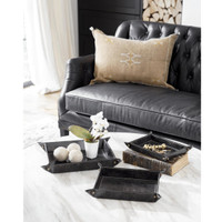 Black genuine leather Derby nesting trays with brass snaps on a marble table.