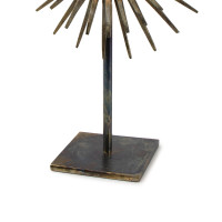 Radiant Sculpture: Industrial-chic patinated iron base with spiked mirror surround.