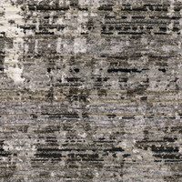 Contemporary polyester rug with abstract patterns in ivory, grey, and black.