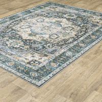 Charleston Blue & Ivory washable polyester rug with distressed traditional design on wood floor.