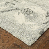 Heathered gray and ivory casual wool rug with a soft, looped texture and rustic floral design.