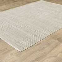Bauer Beige & Ivory Casual Rug, 100% recycled PET yarn, with a subtle geometric pattern on wood floor.