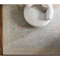 Avant Garde Blue & Light Beige Rug with traditional floral patterns, machine-woven, under a white armchair.