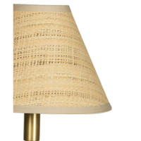 Polly Buffet Lamp with a natural rattan shade and a brass-finished base, casting a warm glow.