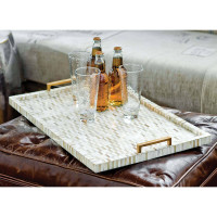Multi-tone bone and brass tray with mosaic pattern, natural brass handles, on a leather ottoman.