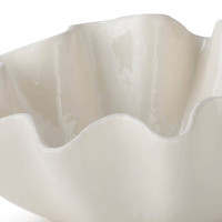 Large creamy white ceramic bowl with ruffled edges.