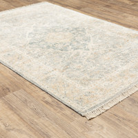 Hand-loomed Malabar Beige & Grey Chenille Traditional Rug with Persian design and fringe on wood floor.