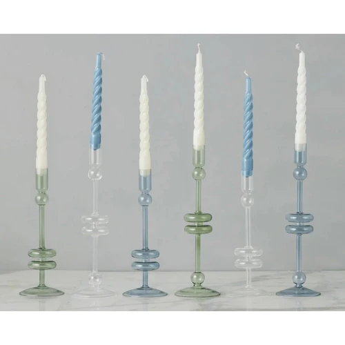 Six elegant glass candlesticks in varying heights, colors, and designs, holding white and blue taper candles.
