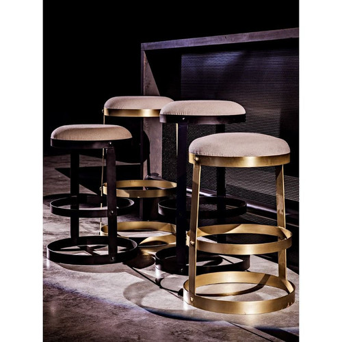 Dior counter stools with beige linen seats and sturdy metal bases in black and antique brass finishes.