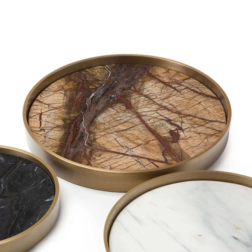 Set of three round marble trays in varied shades (brown, black, white) with natural brass frames.