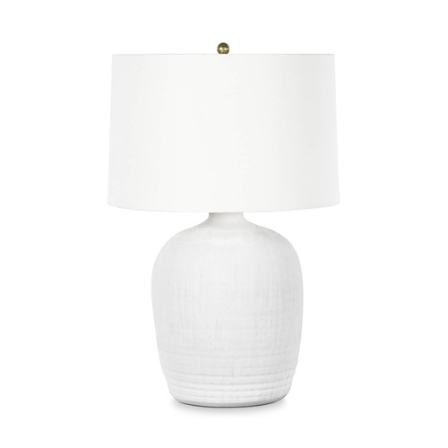 Matte white textured ceramic table lamp with natural brass hardware and a white linen shade.