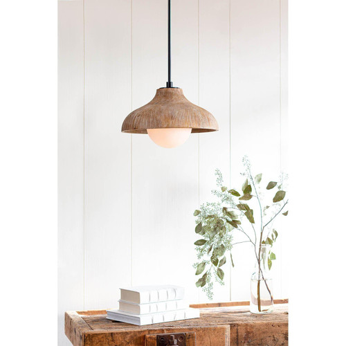 Natural wood grain pendant light with a white-washed finish and milk glass globe, hanging above books and greenery.