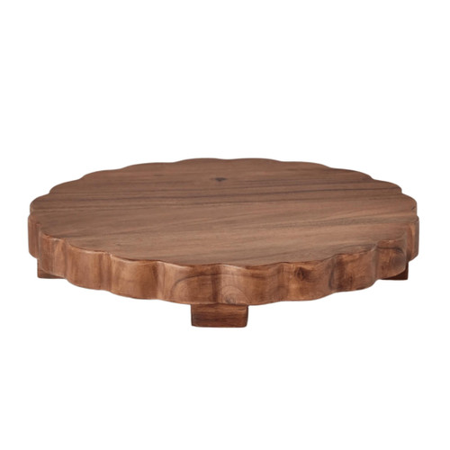 Round scalloped acacia wood charcuterie board with small feet, dark brown finish.