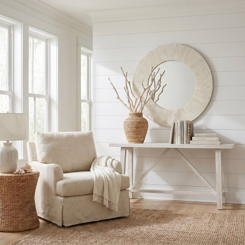 Mirabelle Bone Mirror: Round sunburst design with detailed bone accents in a bright, elegant room.
