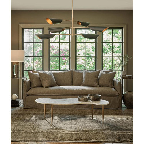 Large mid-century modern Vest Chandelier with six black conical shades and natural brass interior, illuminating a living room.