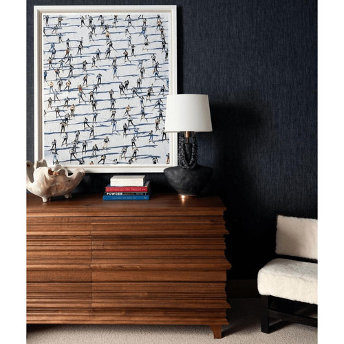 Bernard 6-drawer dark walnut dresser with unique book-stack design, next to a white lamp and artwork.