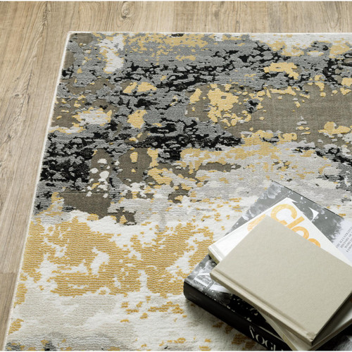 Caravan Beige & Gold Contemporary Rug with abstract design, textured polyester yarns, on a light wood floor.
