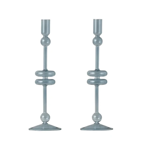 Pair of large denim blue glass candlesticks with elegant, modern design and spherical accents.