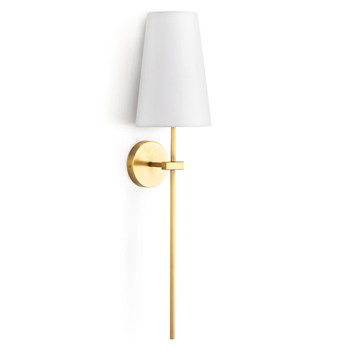 Sleek Toni Brass Sconce with a circular backplate, thin pipe, and tall, tapered natural linen shade.