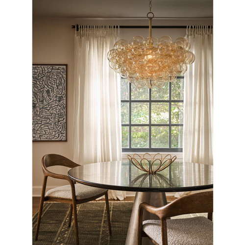 Modern Bubbles Amber Glass Chandelier with a cluster of hand-blown globes over a dining table.
