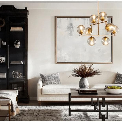 Aiden Aged Brass Globe Chandelier with eight spherical glass lights and gilded linear frames.