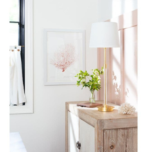Auburn Gold Leaf Crystal Buffet Lamp with a tall, slender gold body and crisp natural linen shade on a wooden cabinet.