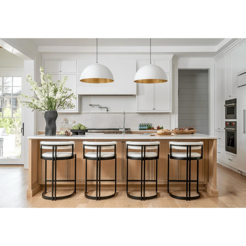 Large white dome pendant light with a gold interior, hanging over a kitchen island.