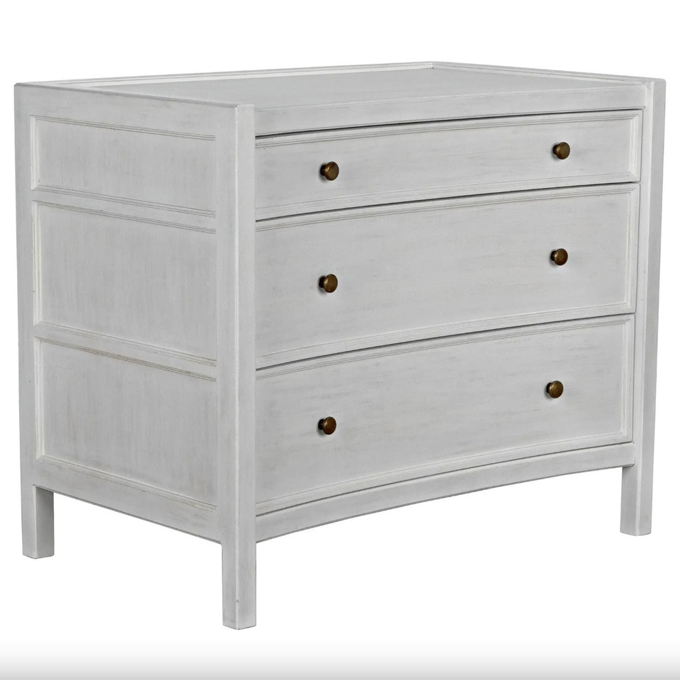 White distressed mahogany Hampton side table with three drawers and metal pulls.