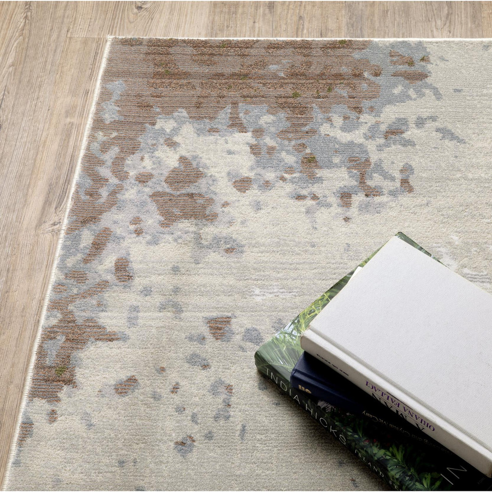 Caravan Beige & Copper Contemporary Rug with abstract copper, gold, indigo, and beige pattern on a wooden floor.