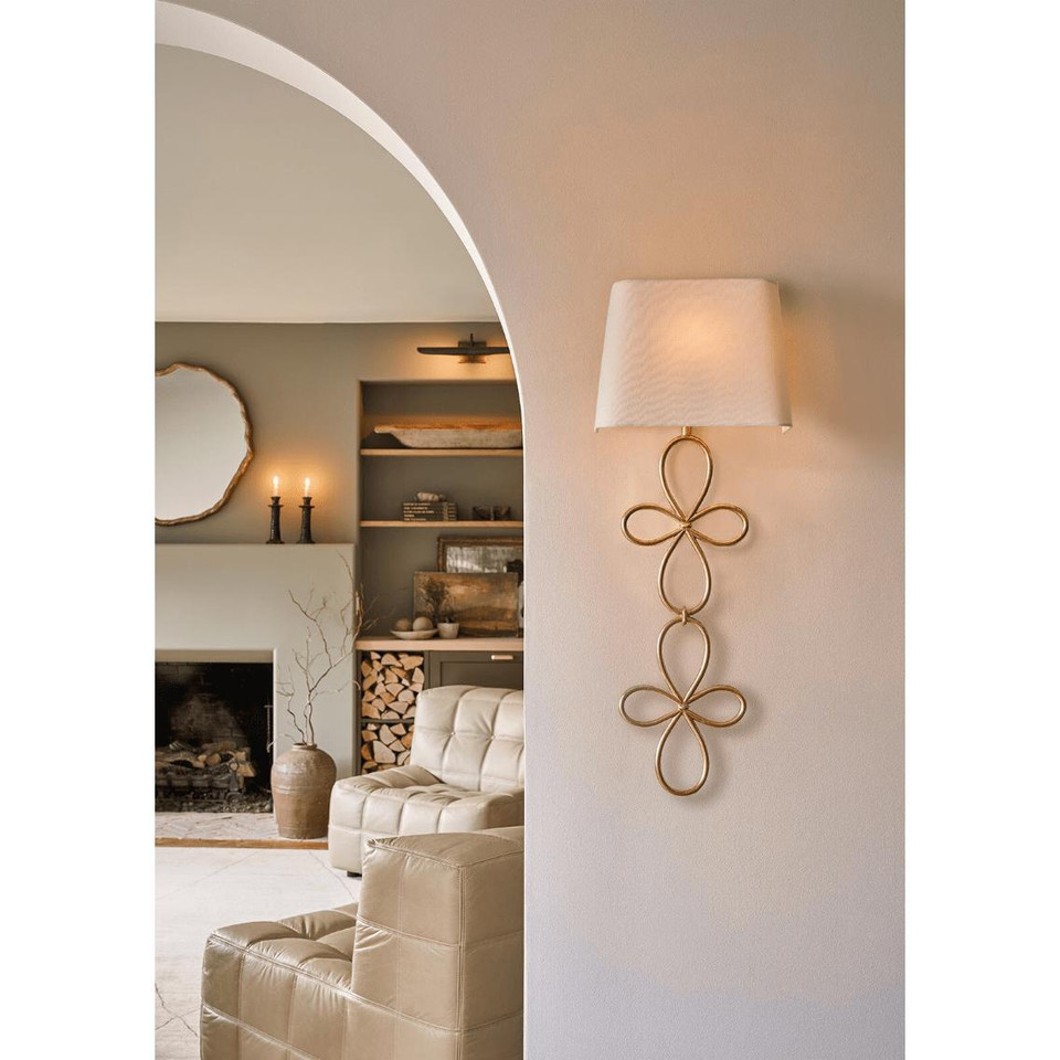 Minuet Gold Leaf Sconce with a white linen shade, featuring elegant, curved gold leaf metalwork.