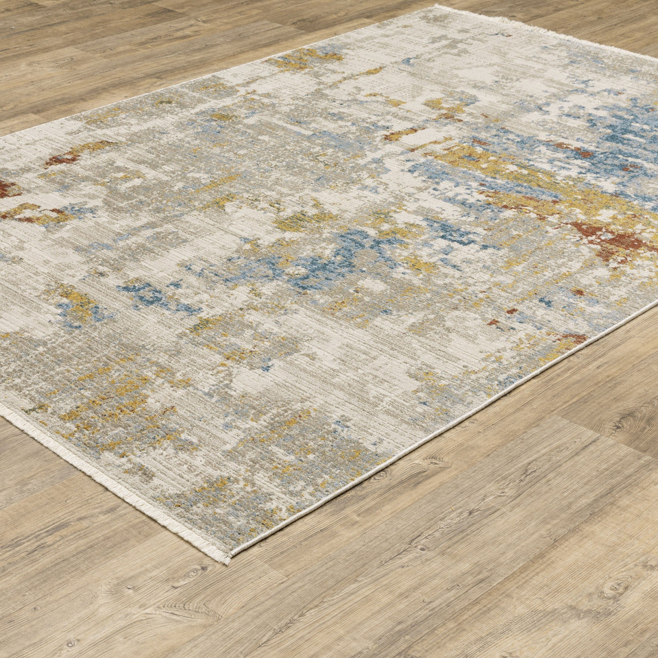 Bauer Beige Multi-Colored Contemporary Rug with abstract blue, gold, and rust accents on a light wood floor.