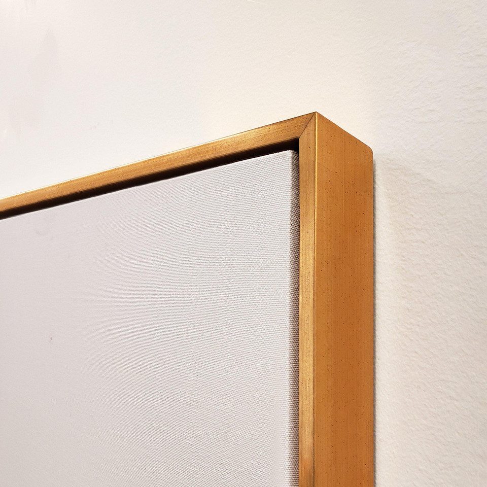 Close-up of a gallery-wrapped giclee canvas painting with a gold floating frame, showing texture.