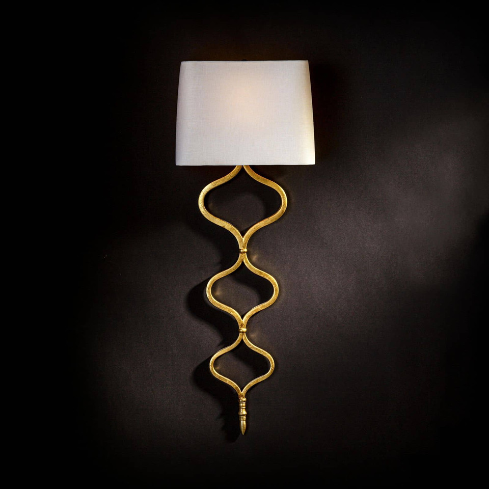 Elegant Sinuous Sconce with gold leaf metal twisting pattern and a natural linen shade.