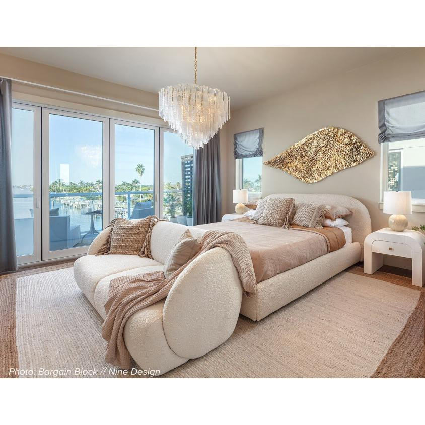 Glacier Glass & Brass Chandelier with striking water glass panes and white swirls, illuminating a modern bedroom.