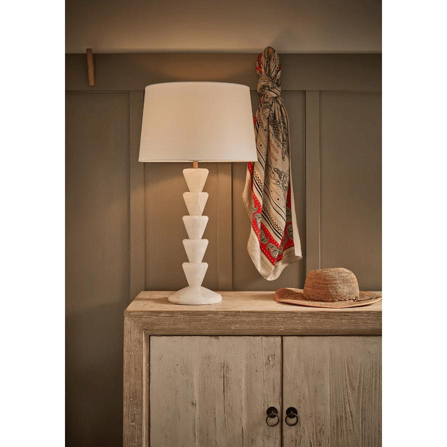 Patricia Jade Table Lamp with a white linen shade and natural jade stone base featuring stacked cone shapes.