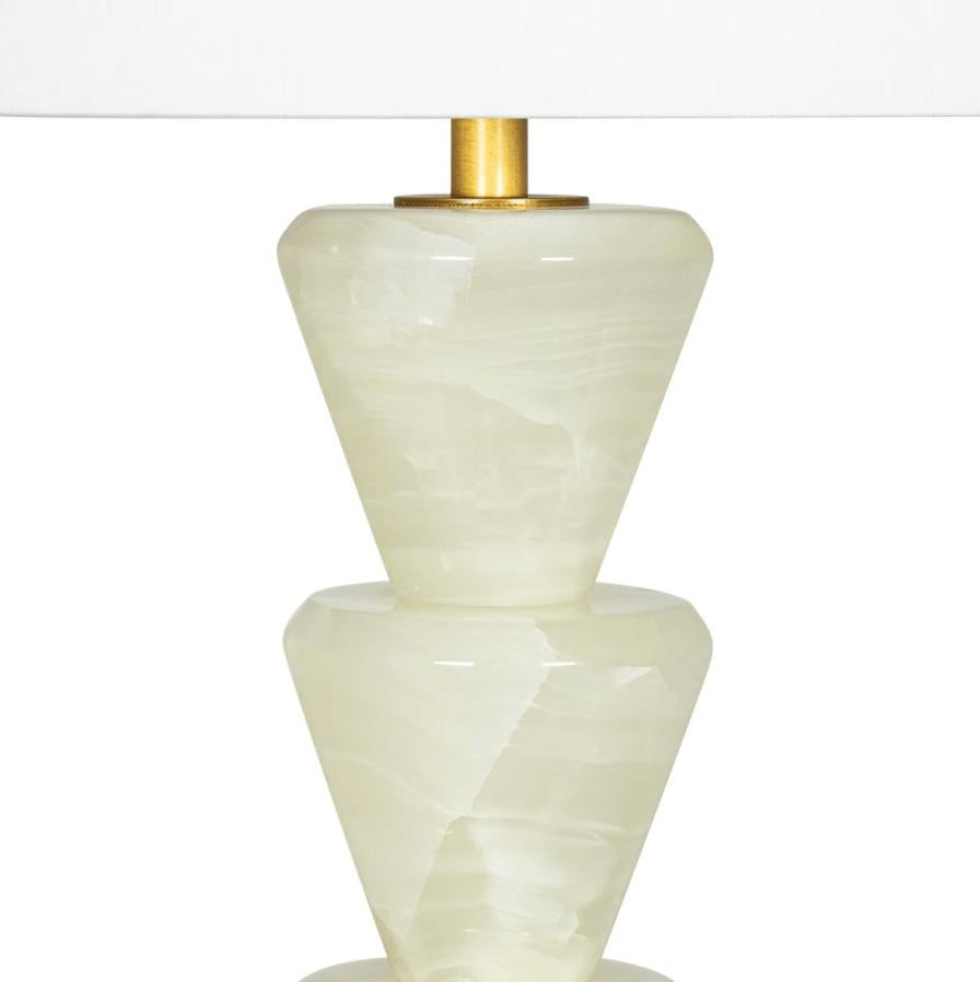 Patricia Jade Table Lamp with a natural jade stone base featuring stacked, downward-facing cone shapes and a white linen shade.