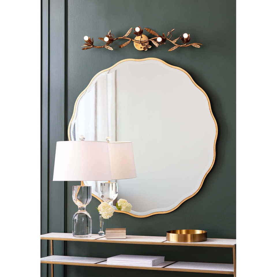 Candice Gold Leaf Mirror with a soft, undulating frame, 32" round, above a console table.
