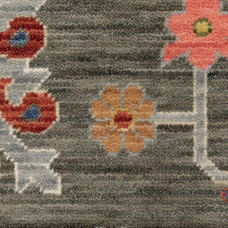 Close-up of Lucca Charcoal & Multi Traditional Rug with space-dyed wool/nylon, featuring floral patterns.