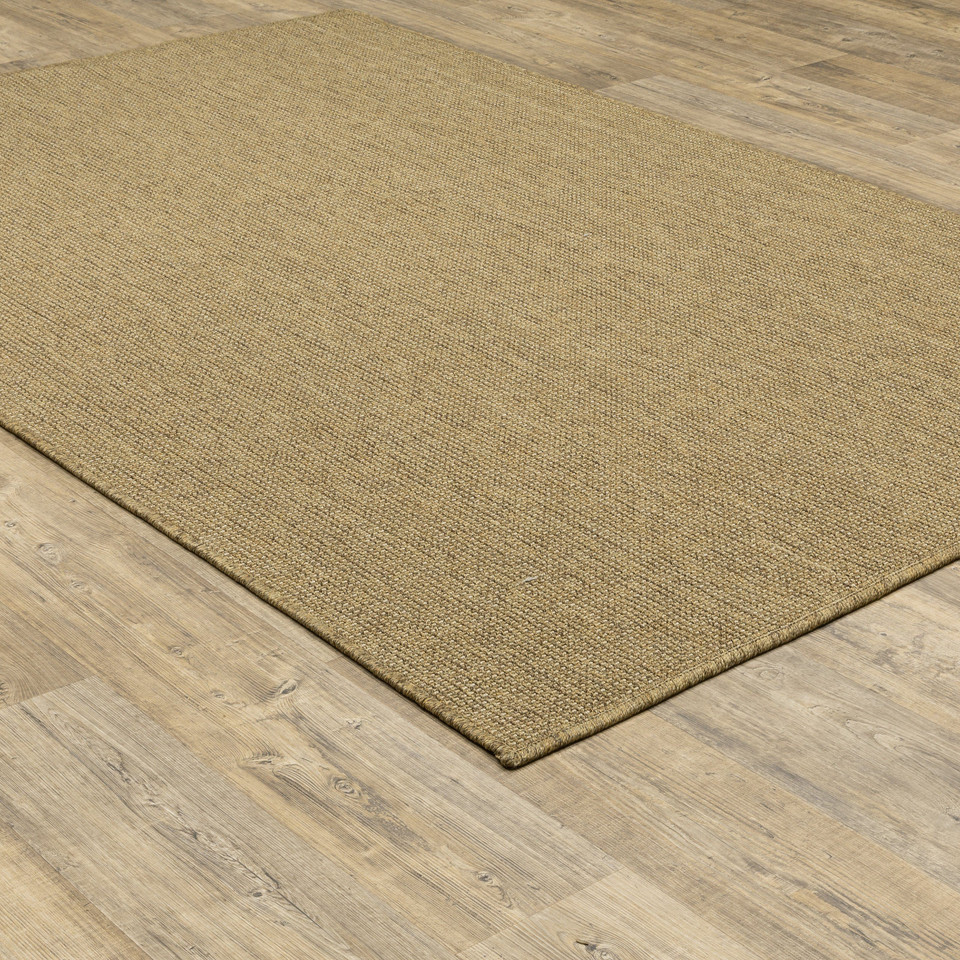 Karavia Tan Outdoor Rug, a durable polypropylene rug with a natural seagrass look on wood flooring.