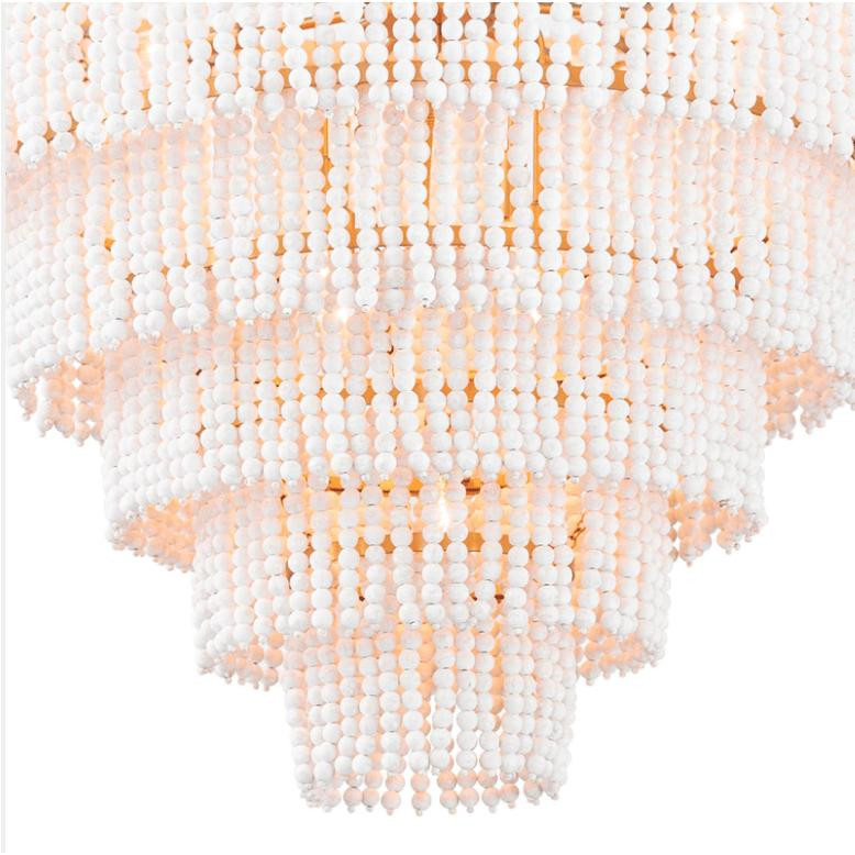 Waterfall White Beaded & Rattan Chandelier with cascading tiers of fresh white beads and warm light.