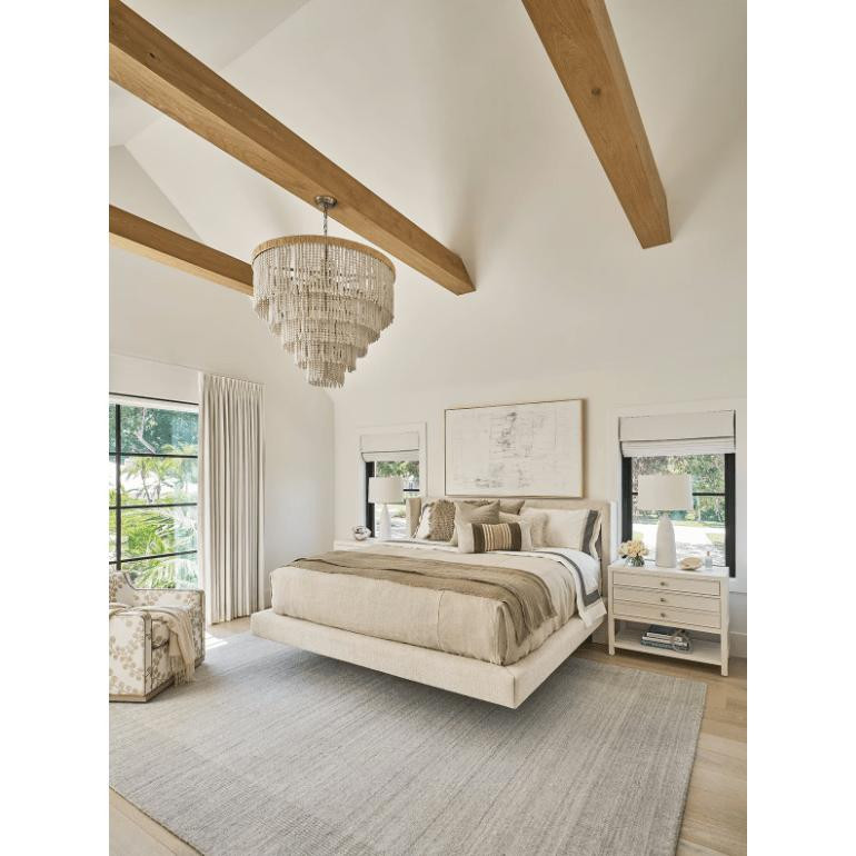 Waterfall White Beaded & Rattan Chandelier with tiered white beads and a jute frame in a bright bedroom.