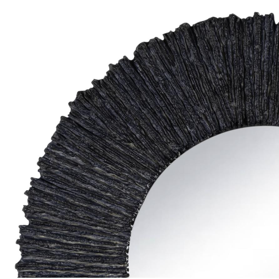 Close-up of a round slate black mirror with a rugged, textured frame, 36" diameter.