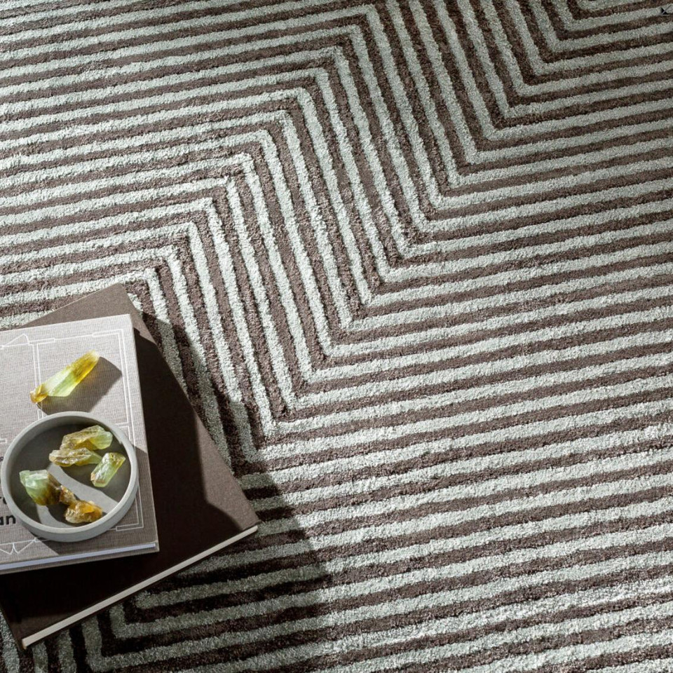 Charcoal grey and light grey striped viscose rug with a modern zigzag pattern.