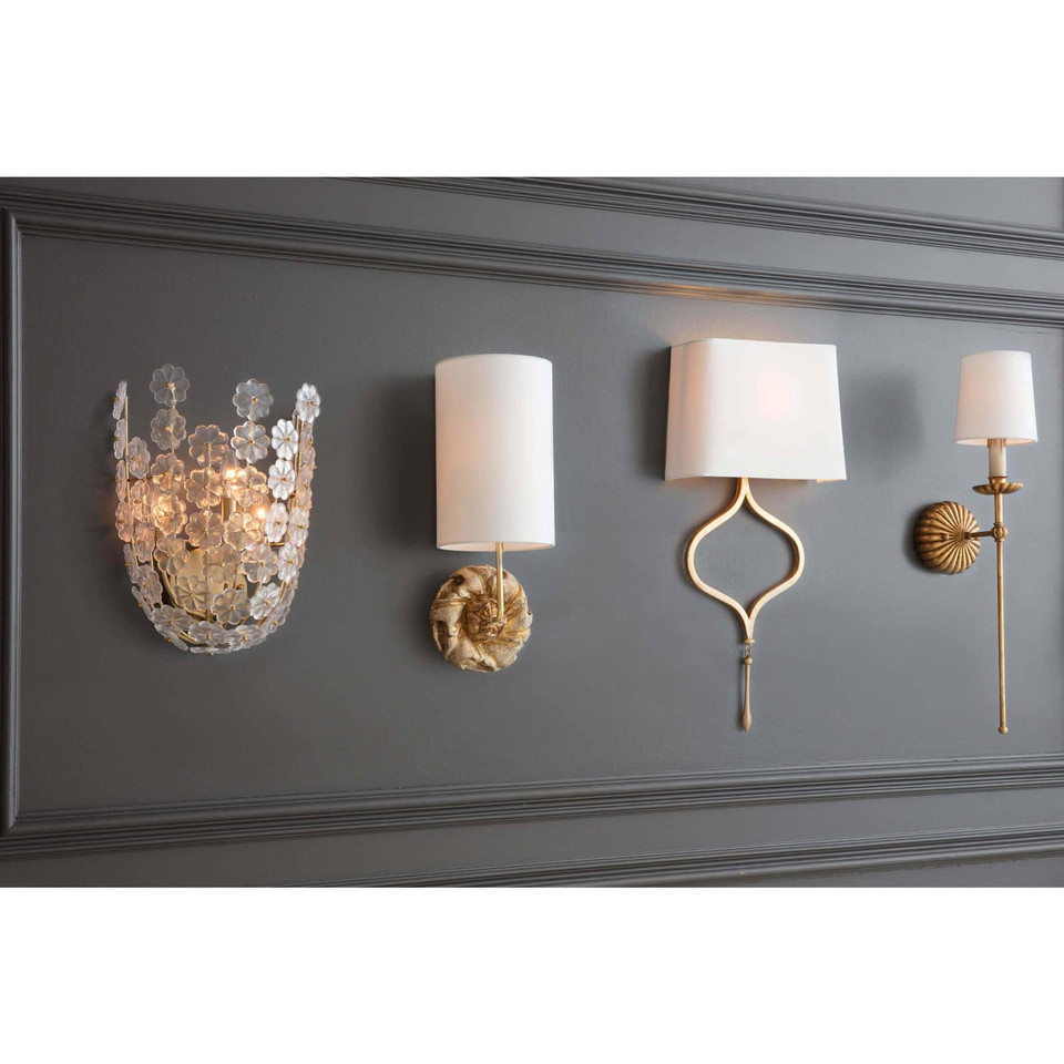 Antique gold leaf Clove Sconce with a white linen shade on a dark gray wall.