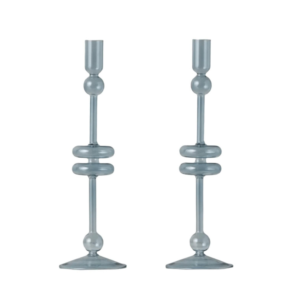 Pair of large denim blue glass candlesticks with elegant, modern design and spherical accents.