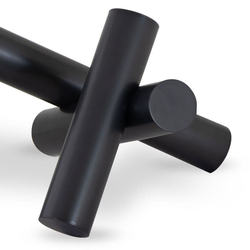 Black Dion Sculpture with four elegant metal cylinders intersecting.